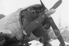 working on engine in snow. Belgium. Jan 1945