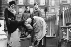 bob and Johns look as Belgian girl has her shoes shined in Brussels Be