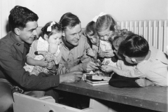 373 officers play with Belgian children at orphanage. Nov 1944