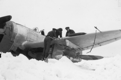 gun inspection on a snow bound P47. Belgium. 1945