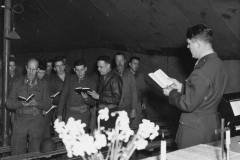 Chaplin reads the scripture at services in special services tent. may