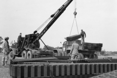 crane lowers landing strips. for 36th fighter group. Kingsnorth. Engla