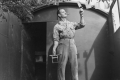 john inspects a negative on back of trailer. Aug 1944