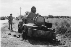 pit inspects a German light armored car.