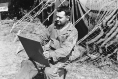 Sgt scannce paints in front of this shop. 391 st svc. France. strip 16