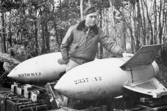 chaplain Saunders exams v3 glided bombs at strip 68. Oct 1944.