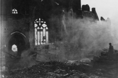 a tankdozer remove rubble near war torn Church in France. 1944