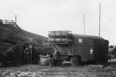 trailer behind our living quarters. bob coming out of air raid shelter