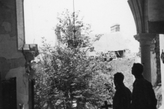 bill and john gaze through shattered Church window in Normandy France