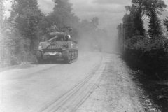 tanks roll along through the dust on way to front. Aug 1944