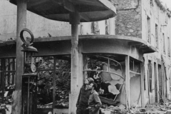 johns and bill gaze at french gas station. France.