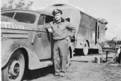 col curry by his car near lab at Le mans France. Sept 1944