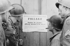 we read a pillage notice on a Normandy building. France.