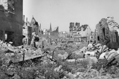 John looks over damage. Kassel, Germany. May 1945.