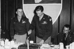 col Douglas looks on as general from 9th tac cuts anniversary cake. ma